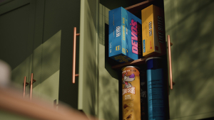 An open kitchen cabinet with cereal boxes on the shelf